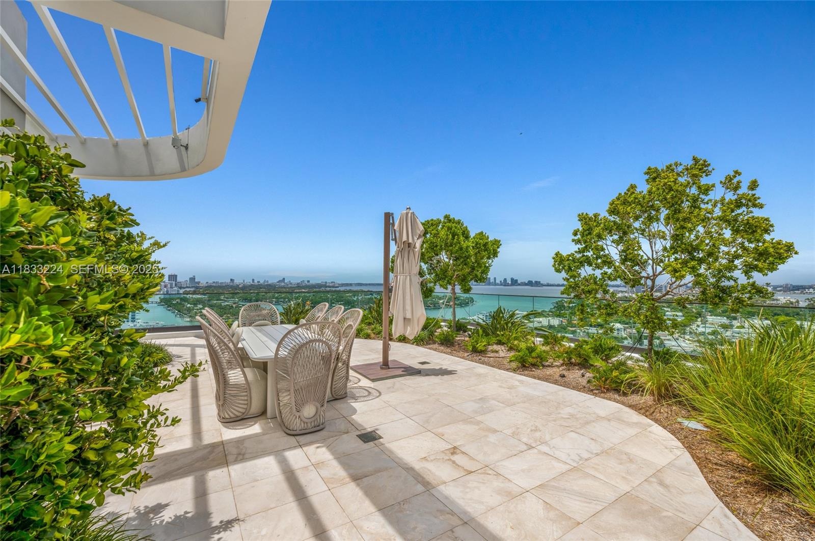 580 72nd Street, Unit 910 Miami Beach, FL 33141 - Photo 13 of 60 a view of a chairs and table in backyard