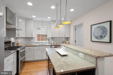 a kitchen with a table chairs sink and cabinets