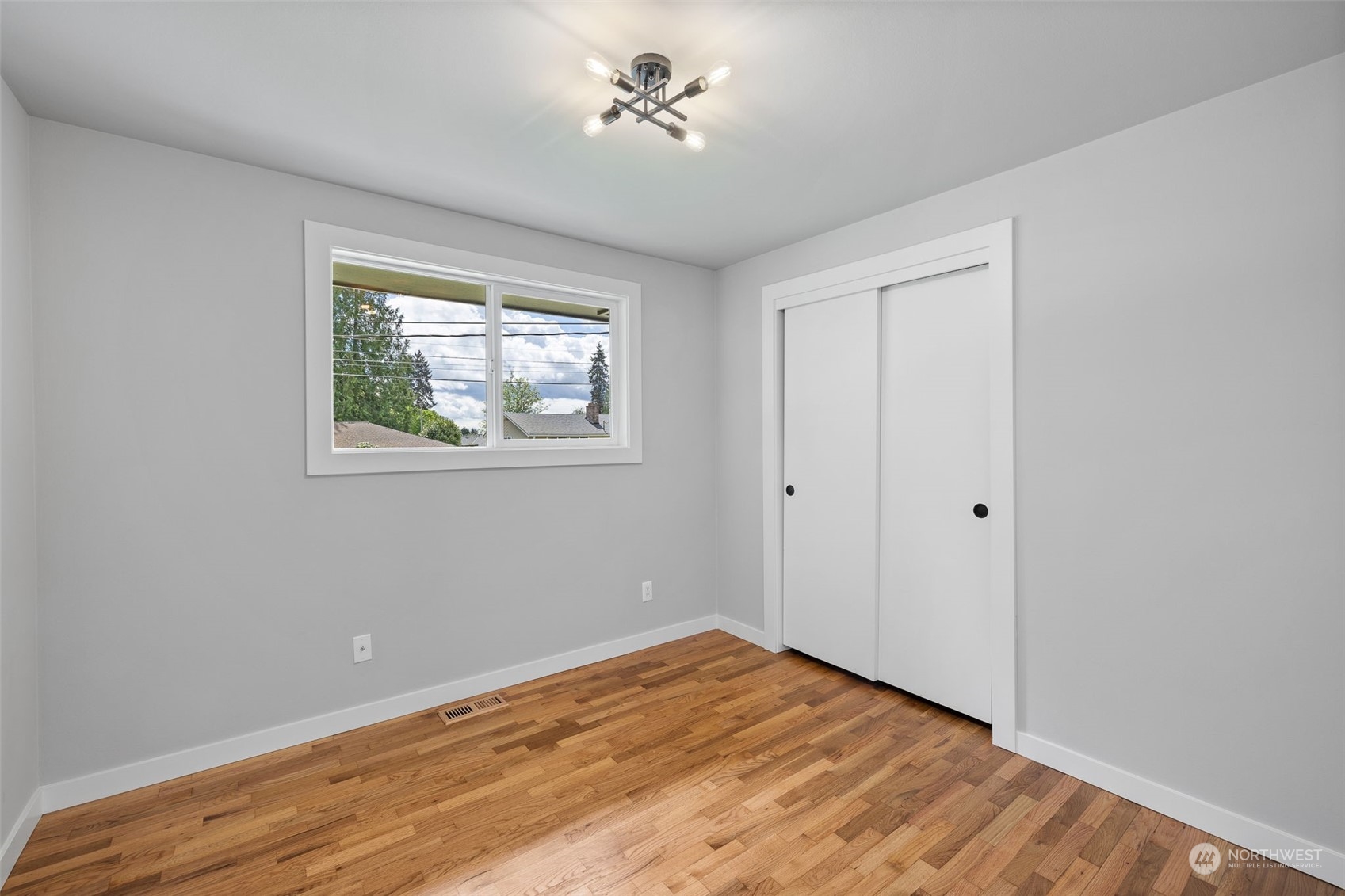 103 234th Street Southwest Bothell, WA 98021 - Photo 20 of 30 a view of empty room with wooden floor and fan