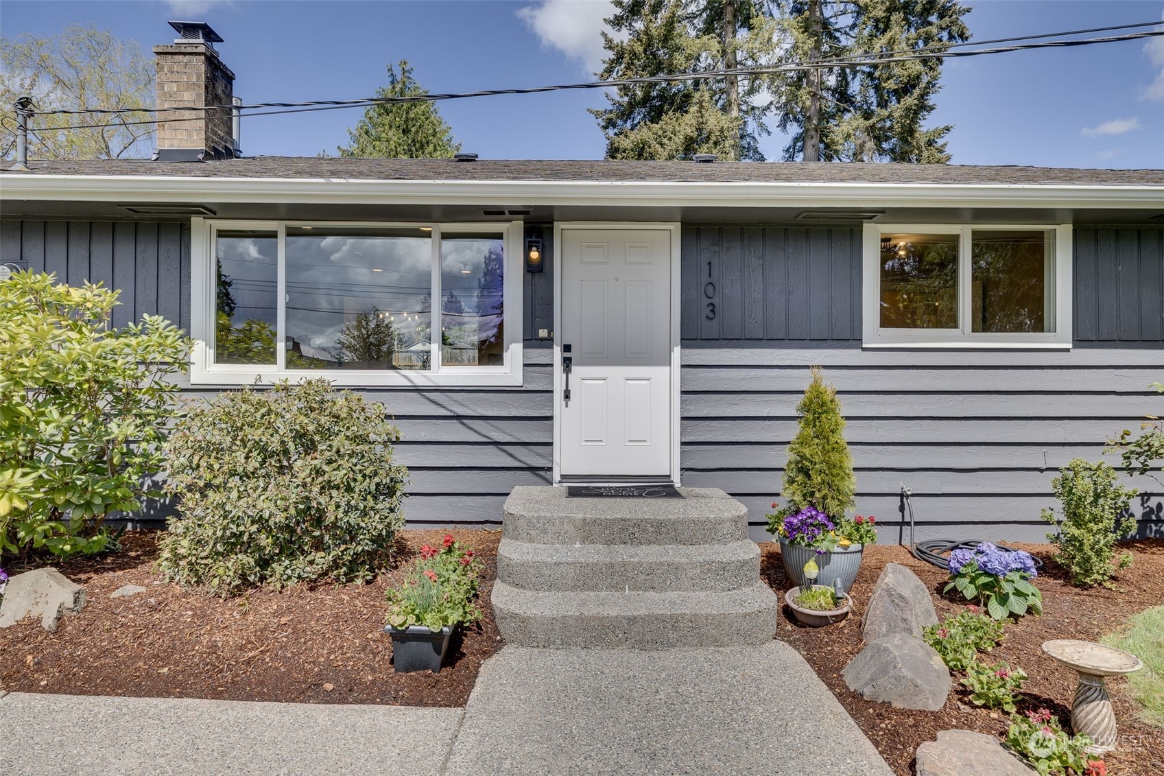 103 234th Street Southwest Bothell, WA 98021 - Photo 2 of 30 a front view of a house with plants