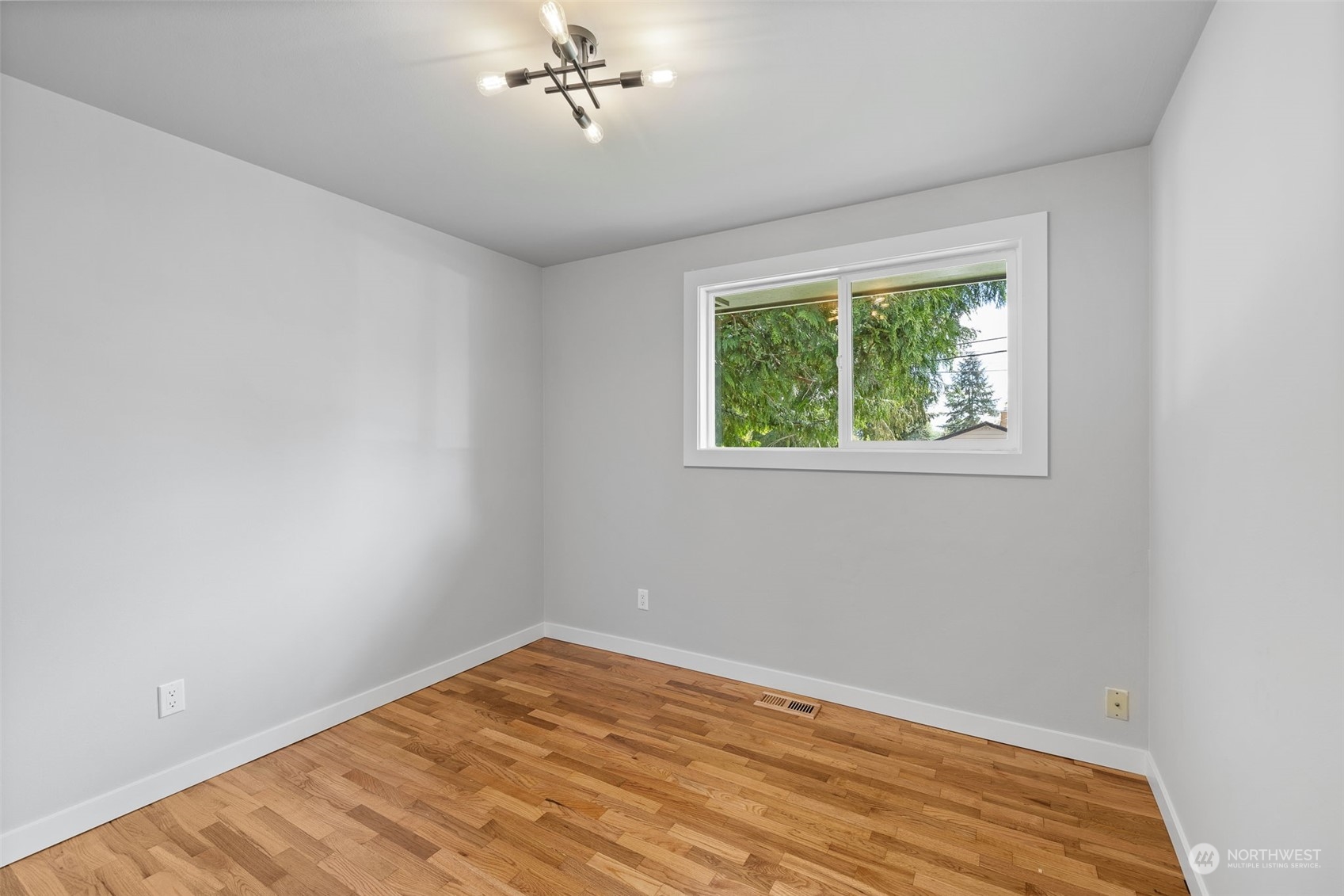 103 234th Street Southwest Bothell, WA 98021 - Photo 21 of 30 a view of empty room with wooden floor