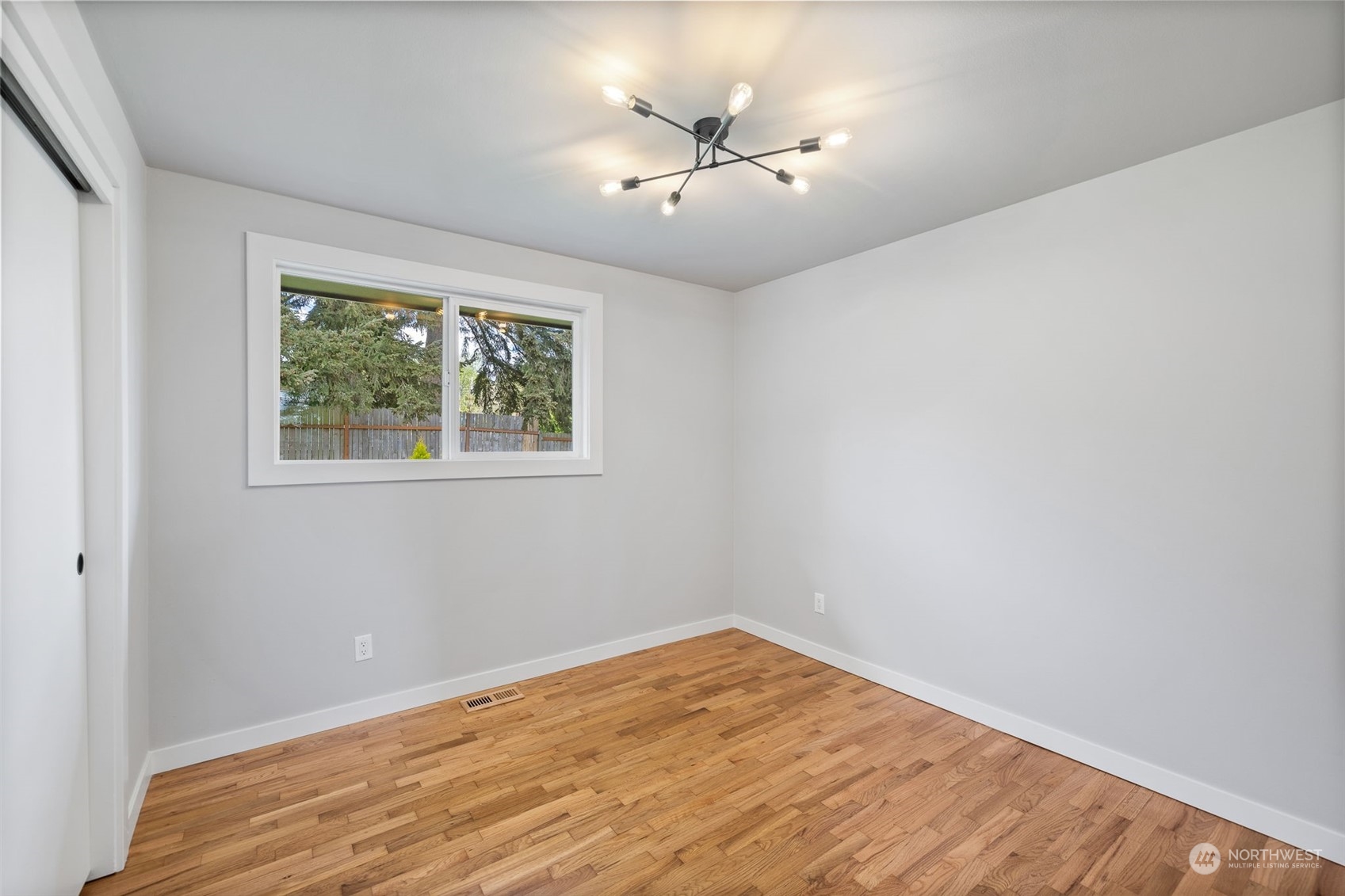 103 234th Street Southwest Bothell, WA 98021 - Photo 23 of 30 a view of empty room with wooden floor