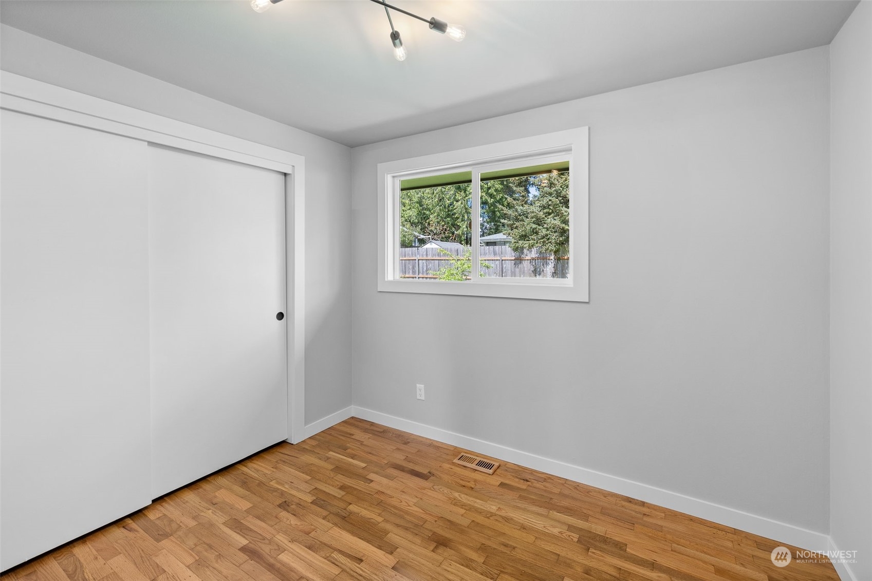 103 234th Street Southwest Bothell, WA 98021 - Photo 24 of 30 an empty room with wooden floor and windows