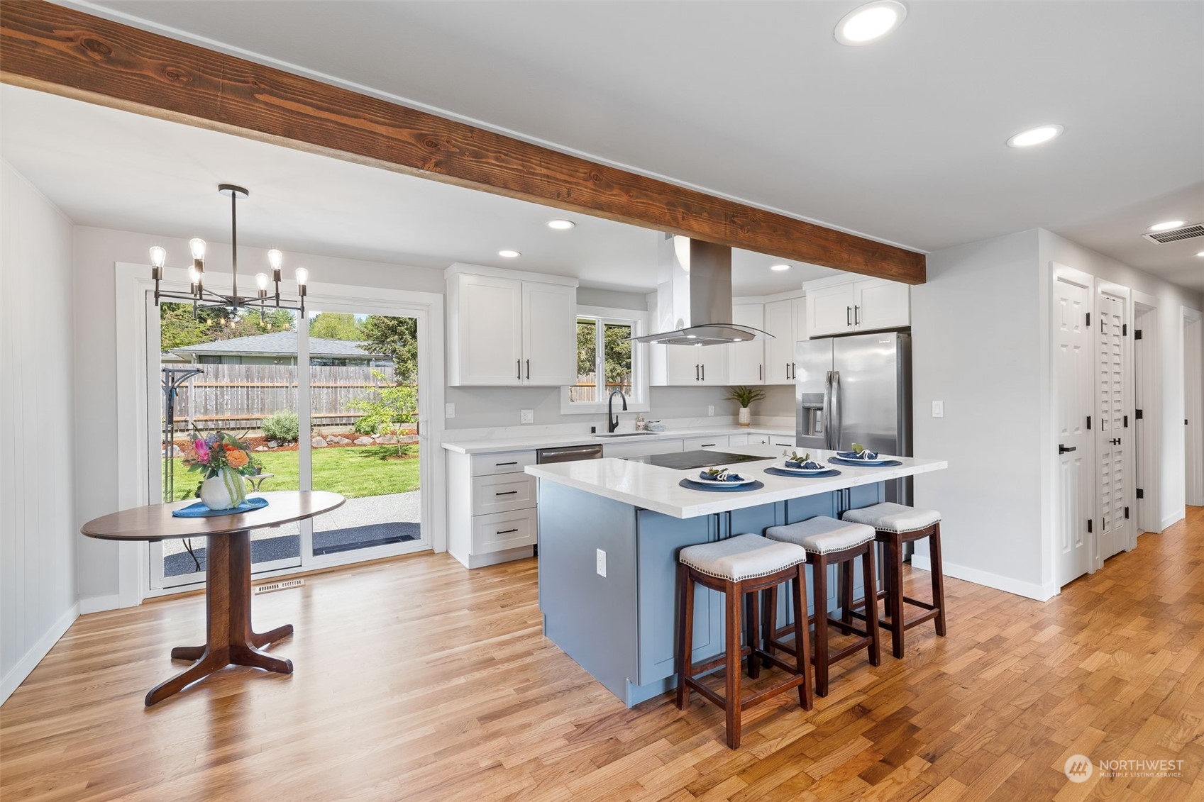 103 234th Street Southwest Bothell, WA 98021 - Photo 8 of 30 a kitchen with stainless steel appliances a dining table chairs stove refrigerator and cabinets