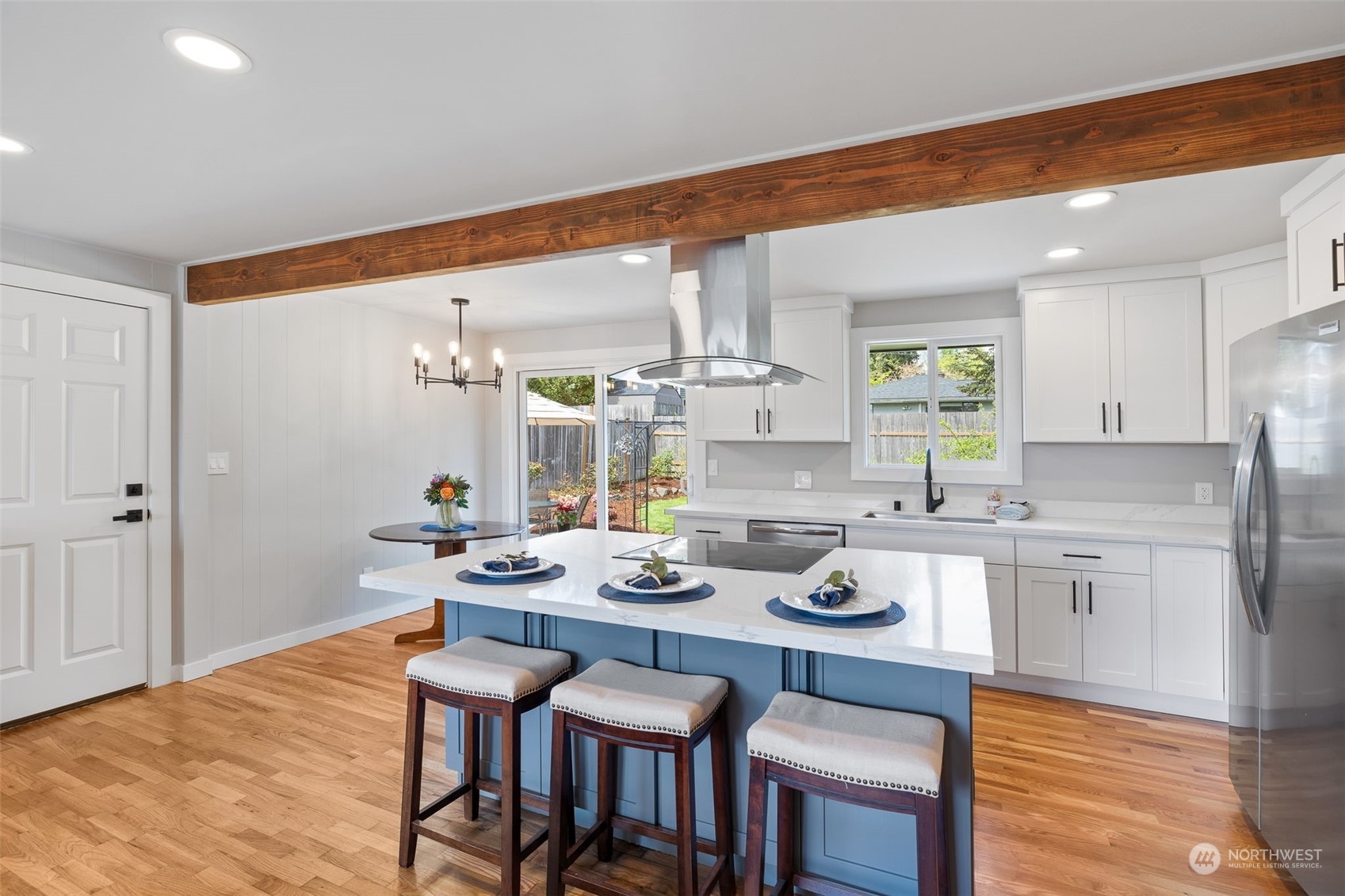 103 234th Street Southwest Bothell, WA 98021 - Photo 9 of 30 a kitchen with a dining table chairs stove and white cabinets