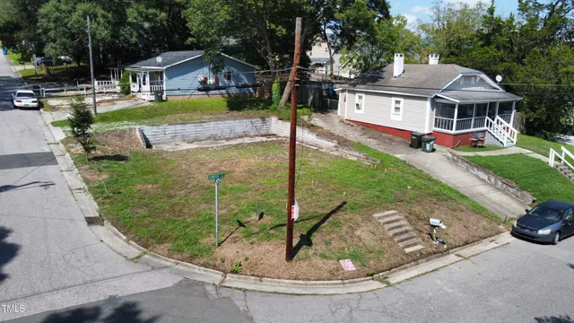 a aerial view of a house with a yard table and chairs