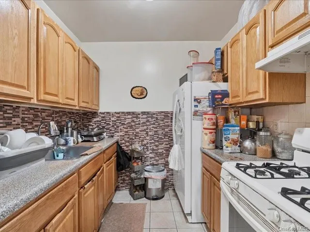 a kitchen with a sink and a stove top oven