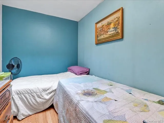 a bedroom with a bed and a painting on the wall