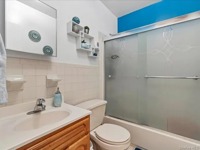 a bathroom with a sink a toilet and shower curtain