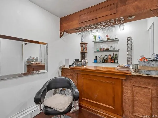 a room with cabinets a sink and a mirror