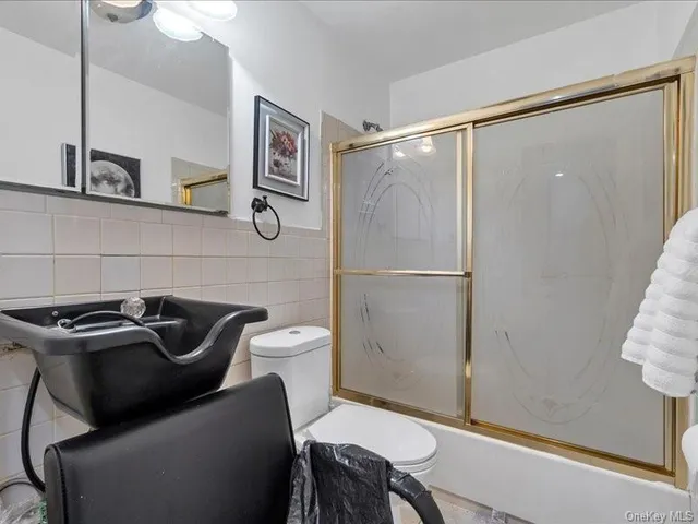 a bathroom with a sink a toilet and a shower