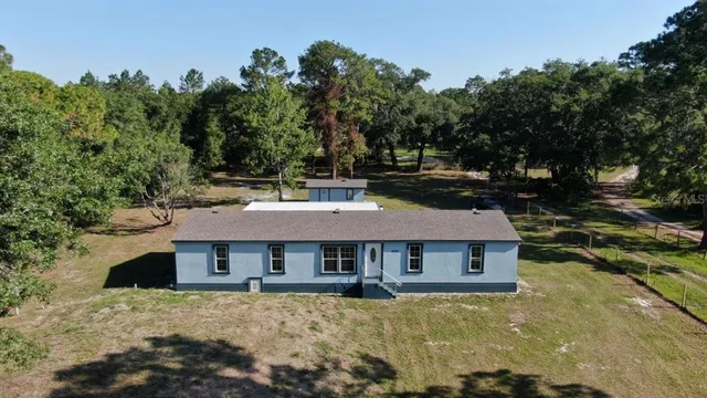 aerial view of a house with a yard