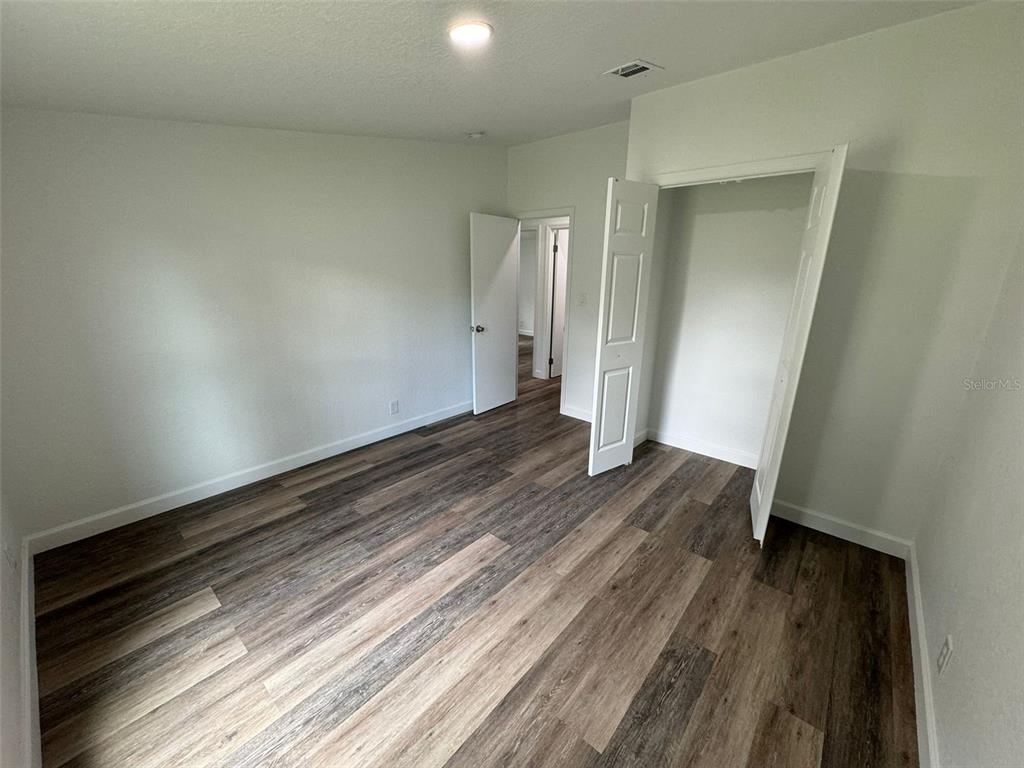 4970 Harrison Road Mims, FL 32754 - Photo 17 of 30 a view of an empty room and wooden floor