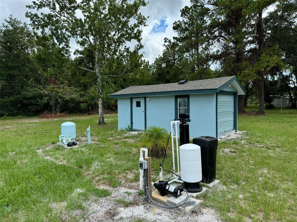 4970 Harrison Road Mims, FL 32754 - Photo 26 of 30 a view of a backyard with table and chairs and a barbeque