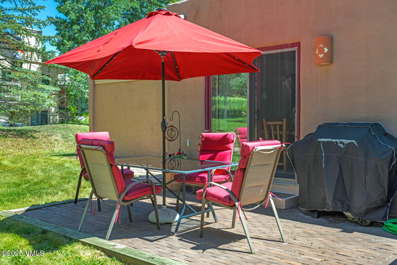 20 Hereford Road Edwards, CO 81632 - Photo 29 of 32 a patio with a table and chairs under an umbrella
