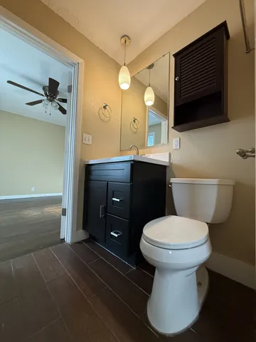 a bathroom with a sink toilet a mirror and vanity