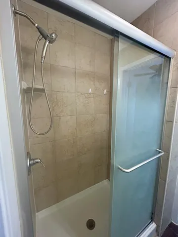 a bathroom with a glass shower door