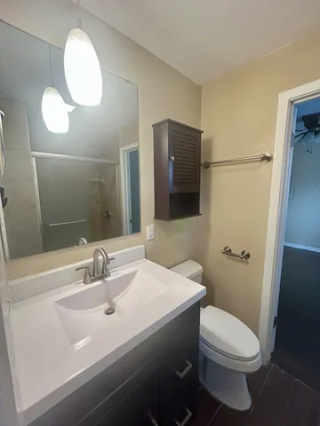 a bathroom with a sink toilet and shower