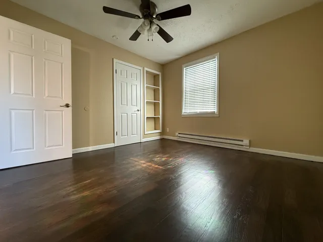 a view of a livingroom with wooden floor and a window
