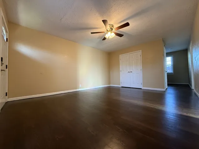 a view of a room with wooden floor and windows