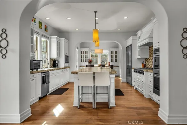 a dining room with furniture a chandelier and wooden floor