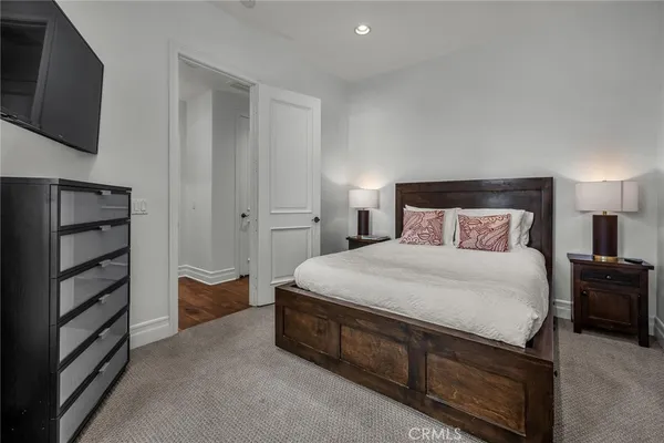 a spacious bedroom with a bed and a large window