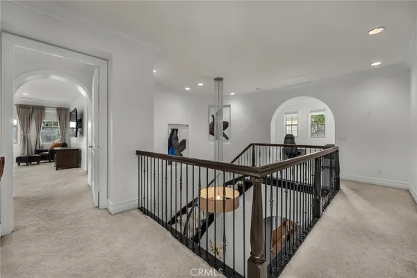 a spacious bedroom with a bed a couch and a flat screen tv