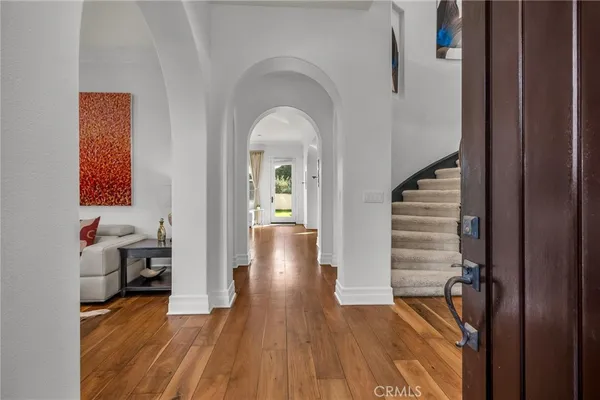 a view of entryway livingroom and hall with wooden floor
