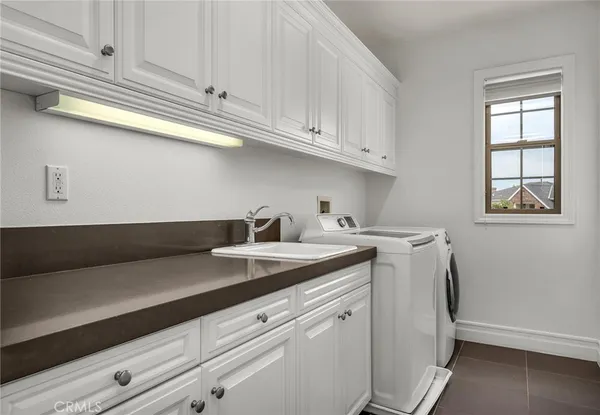 a view of a house with a yard and large tree