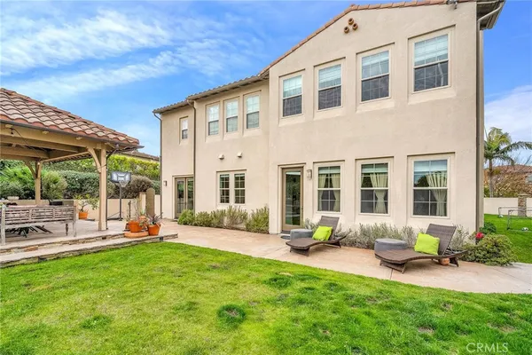 a living room with fireplace furniture and a large window