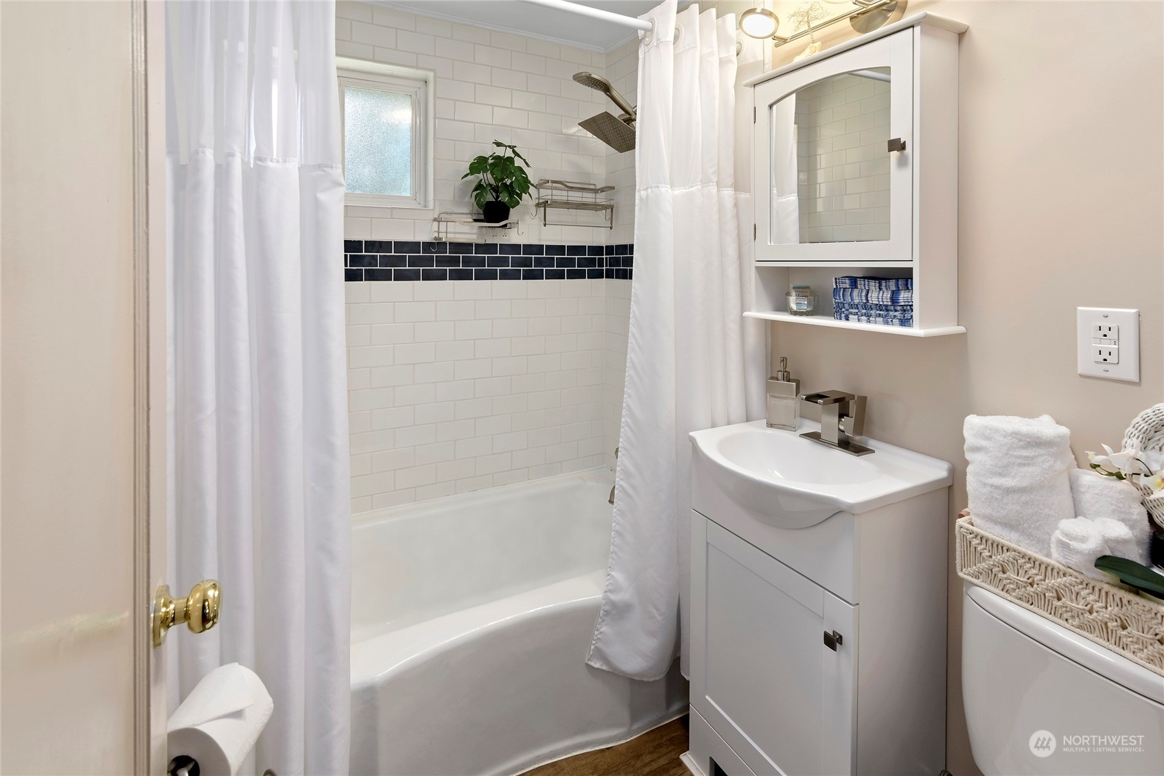 3609 Southeast 5th Place Renton, WA 98058 - Photo 12 of 40 a bathroom with a sink and mirror with bathtub