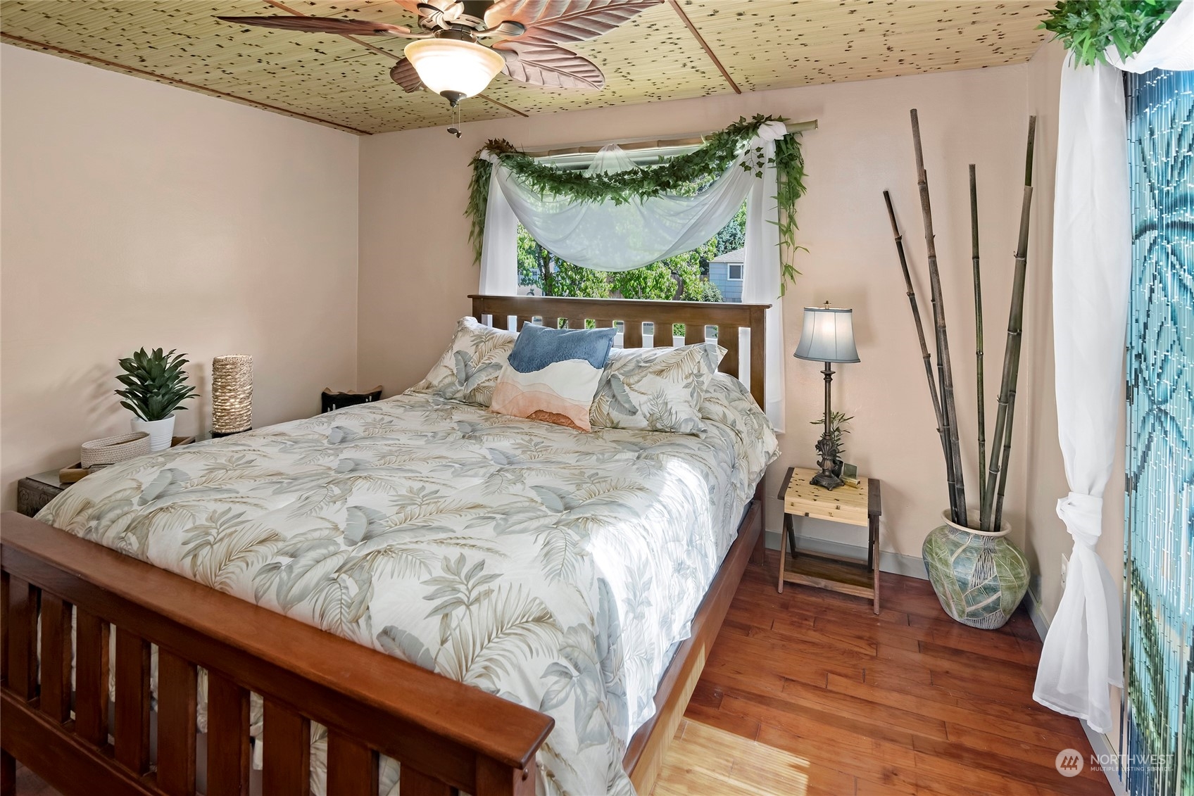 3609 Southeast 5th Place Renton, WA 98058 - Photo 14 of 40 a bed sitting in a bedroom next to a window with kitchen chandelier