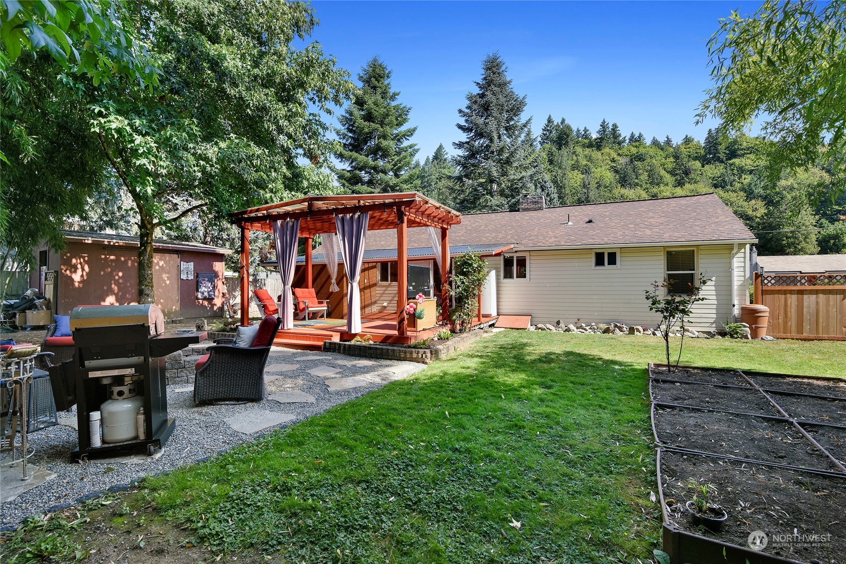 3609 Southeast 5th Place Renton, WA 98058 - Photo 30 of 40 a view of a house with backyard sitting area and garden