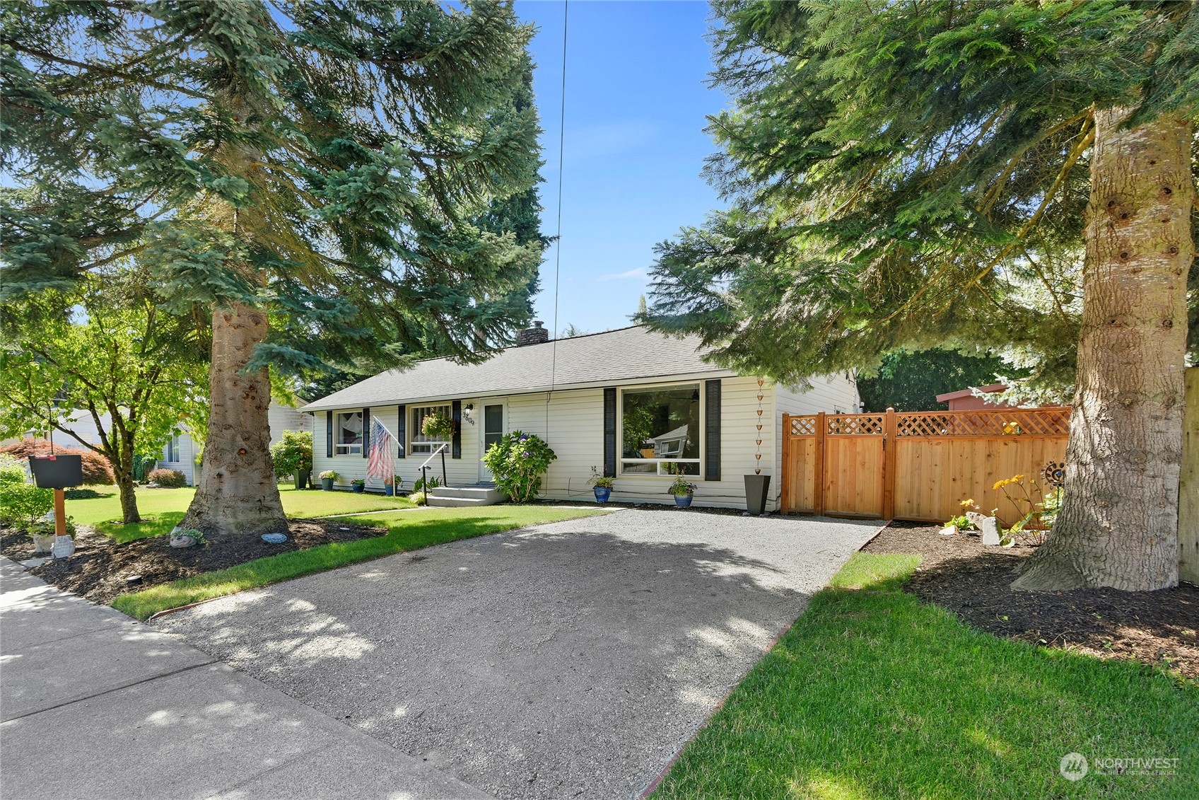 3609 Southeast 5th Place Renton, WA 98058 - Photo 4 of 40 a front view of a house with a yard and trees