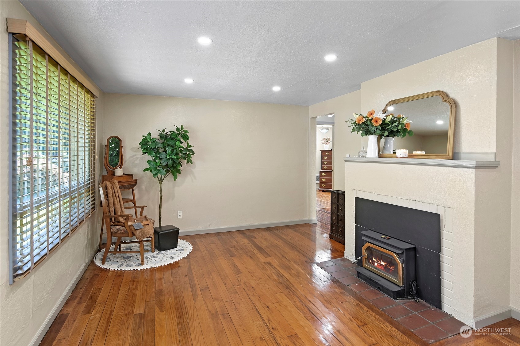 3609 Southeast 5th Place Renton, WA 98058 - Photo 7 of 40 a view of an empty room with wooden floor and a fireplace