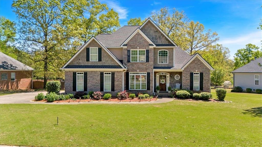 a front view of house with yard outdoor seating and green space
