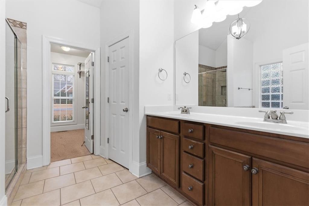16 Quarter Horse Drive Northwest Rome, GA 30165 - Photo 19 of 51 a spacious bathroom with a double vanity sink a large mirror a shower and a bathtub