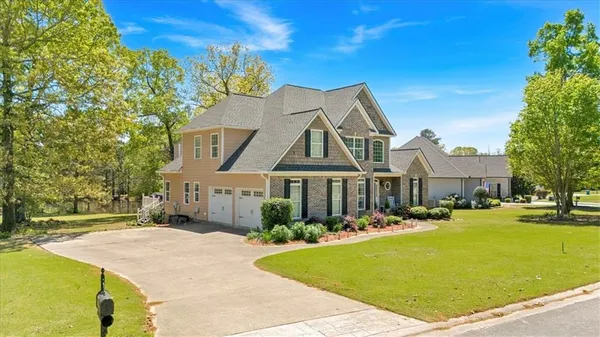 a front view of a house with a yard