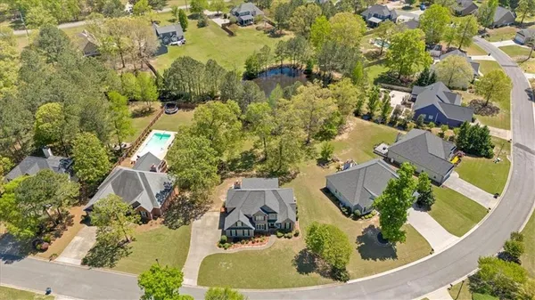 an aerial view of a residential houses with yard