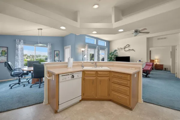 a kitchen with kitchen island a sink stainless steel appliances and dining table
