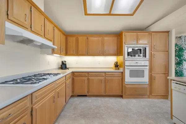 a kitchen with stainless steel appliances granite countertop a stove and a refrigerator