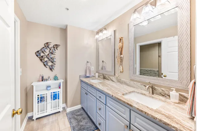 a view of a hallway with bathroom and glass door