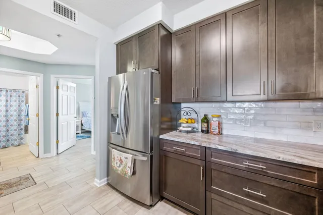 a spacious bathroom with a granite countertop sink a mirror and a shower