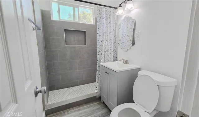 a bathroom with a toilet sink and shower