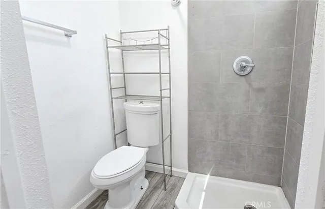 a white toilet sitting next to a bath tub shower