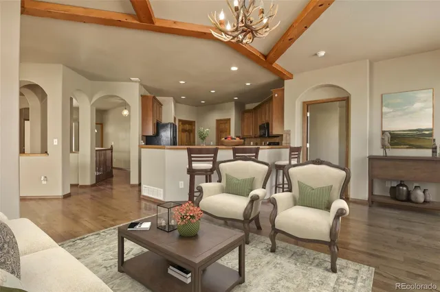 a living room with furniture ceiling fan and a rug