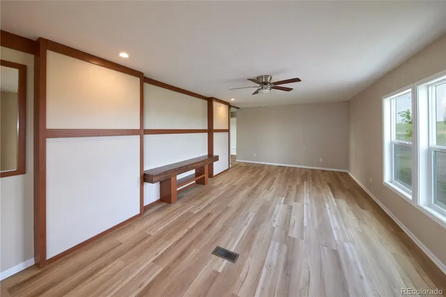 wooden floor in an empty room with a window