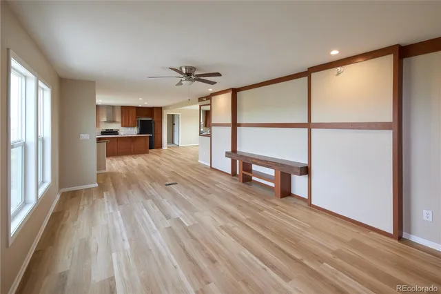 a view of empty room with wooden floor and window