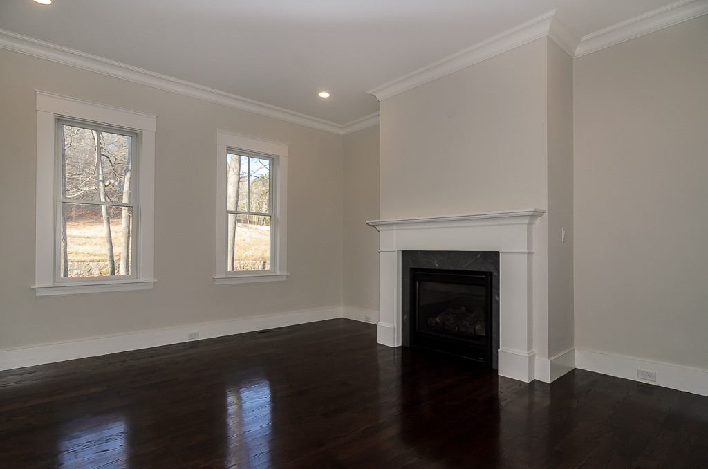 2 Leighton Road Wellesley, MA 02482 - Photo 3 of 16 a view of an empty room with wooden floor fireplace and a window