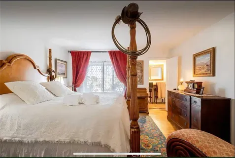 a bedroom with a bed and a night stand